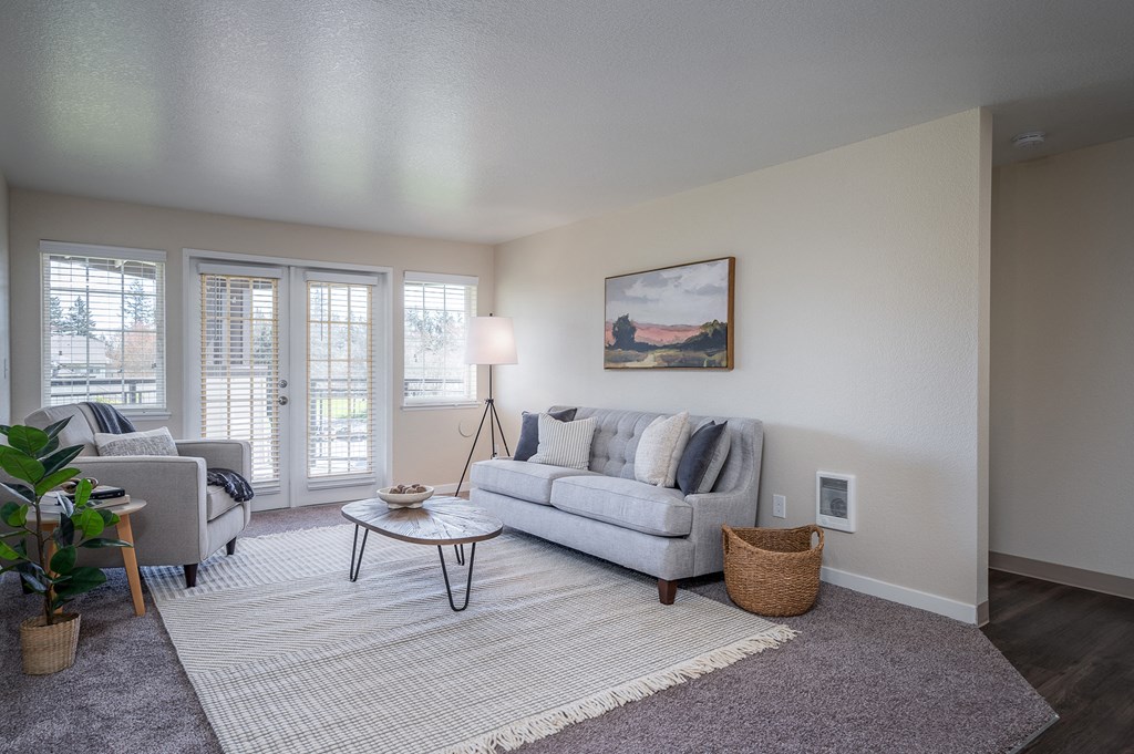 a living room with a couch and a chair and a window at Sundial Apartments, Wilsonville, 97070