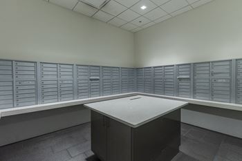 an empty room with lockers and a table in the middle