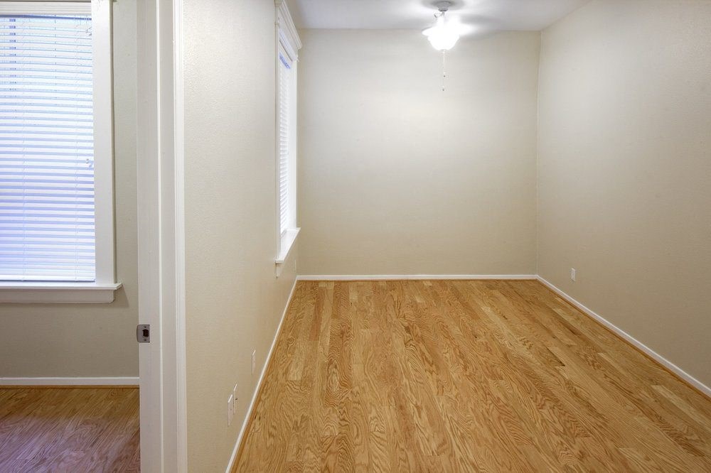 bedroom with wood flooring and a window