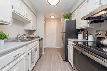 a renovated kitchen with white cabinets and a black stove and refrigerator at Williamsburg South, Pennsylvania