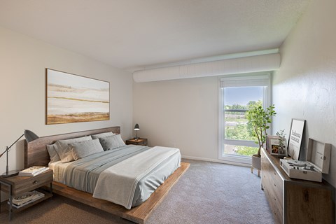 A bedroom with a large bed and a painting on the wall.