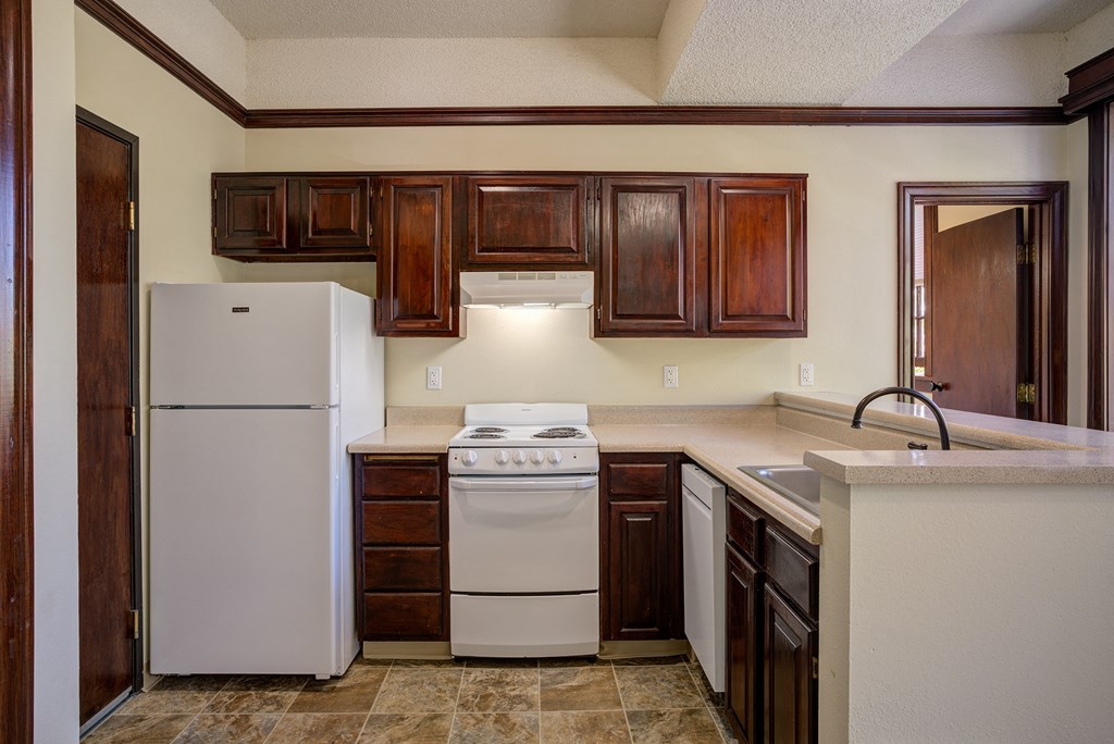 a kitchen with white appliances and dark wood cabinets at Whitney Gray, Portland, 97205 ?