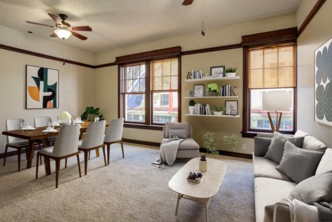 A living room with a dining table and chairs.
