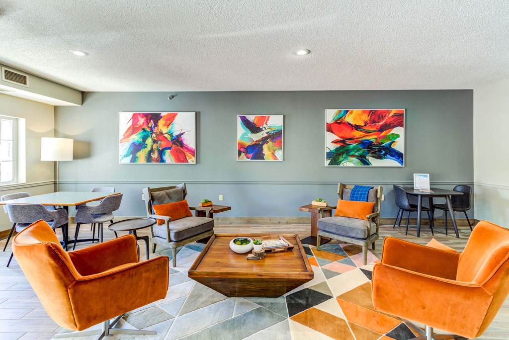 a living room with orange chairs and a coffee table on a checkered floor