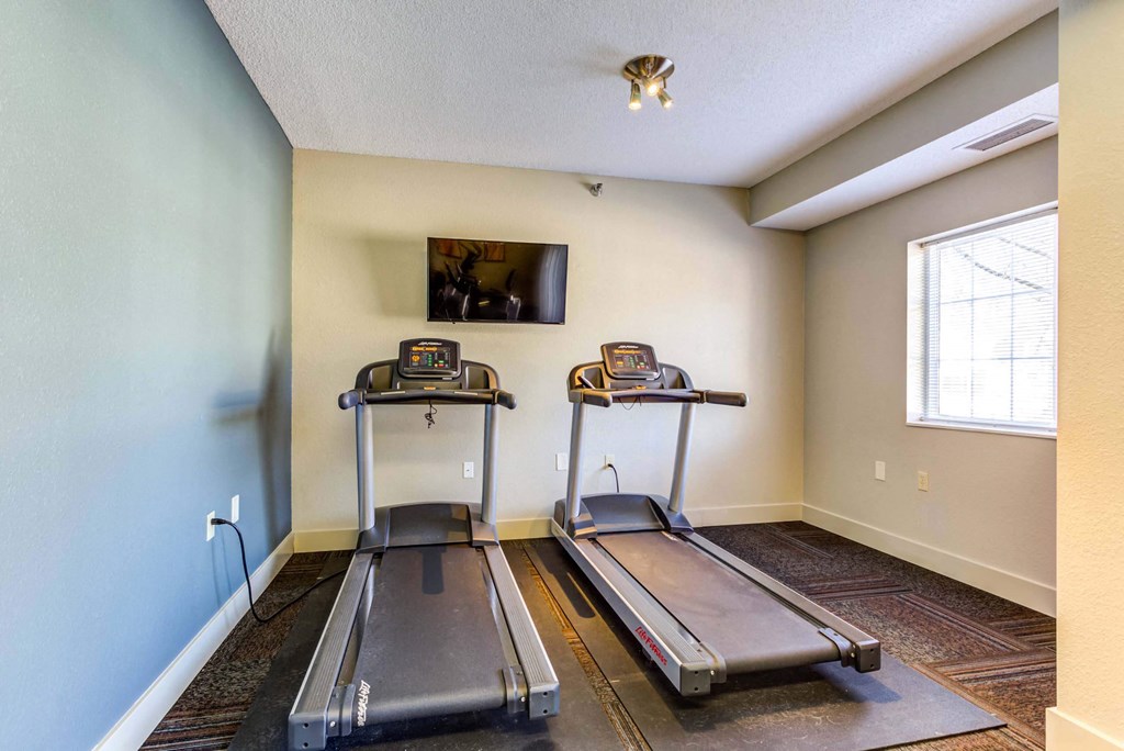 the treadmill area in the fitness room at the whispering winds apartments in pearland, tx