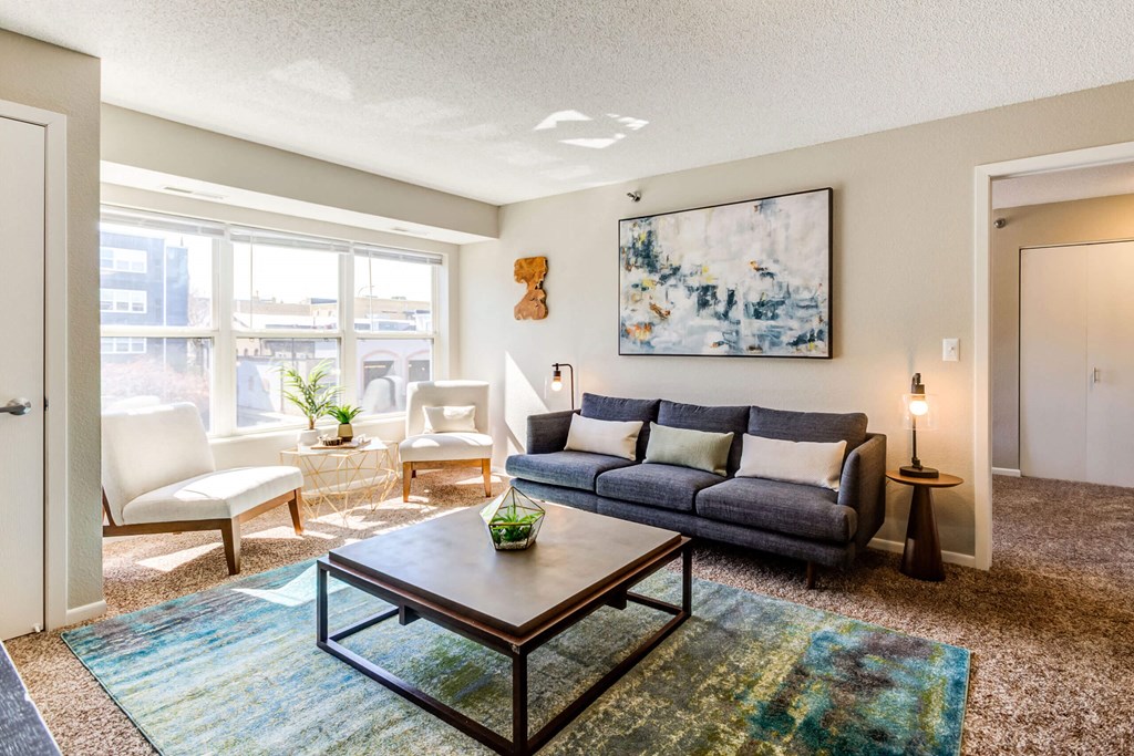 a living room with a large window and a couch