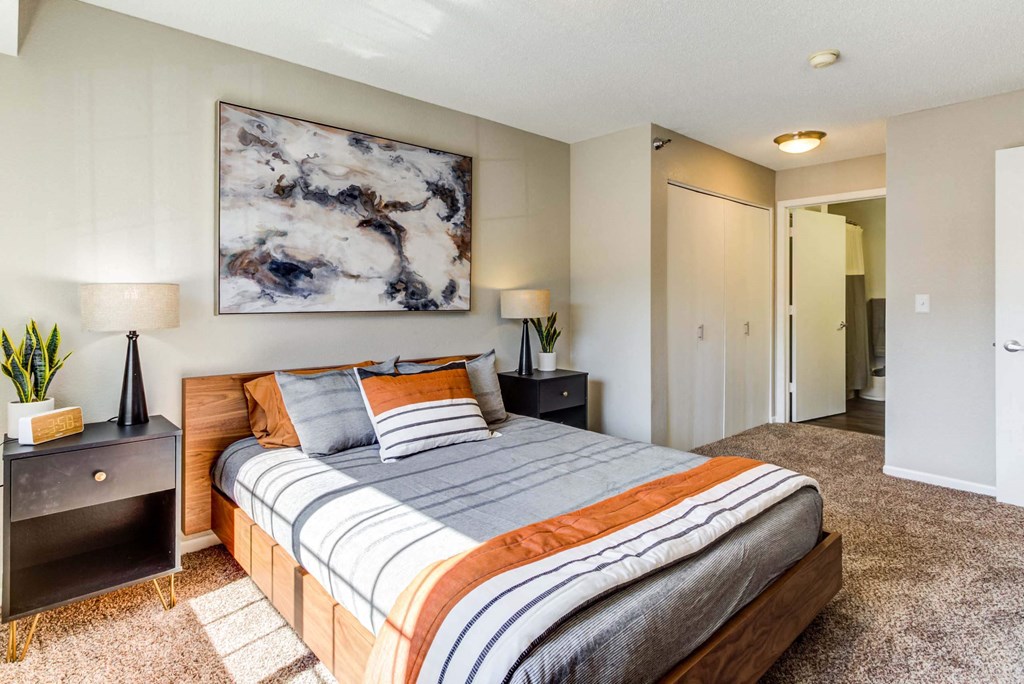 a bedroom with a bed and two night stands