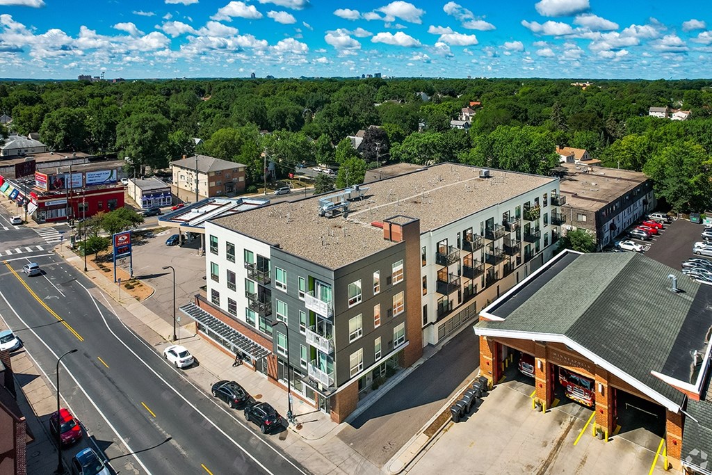 A street view of a town with a large building in the center.