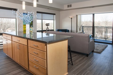 A kitchen with wooden cabinets and a black countertop.