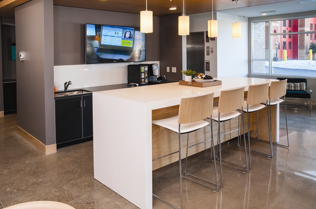 A modern kitchen area with a bar stool.