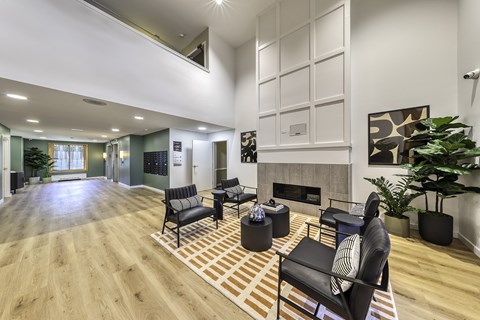 A living room with a fireplace and a large painting on the wall.