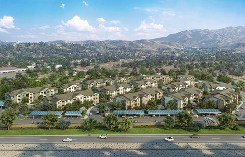 A large housing complex with a parking lot in front.