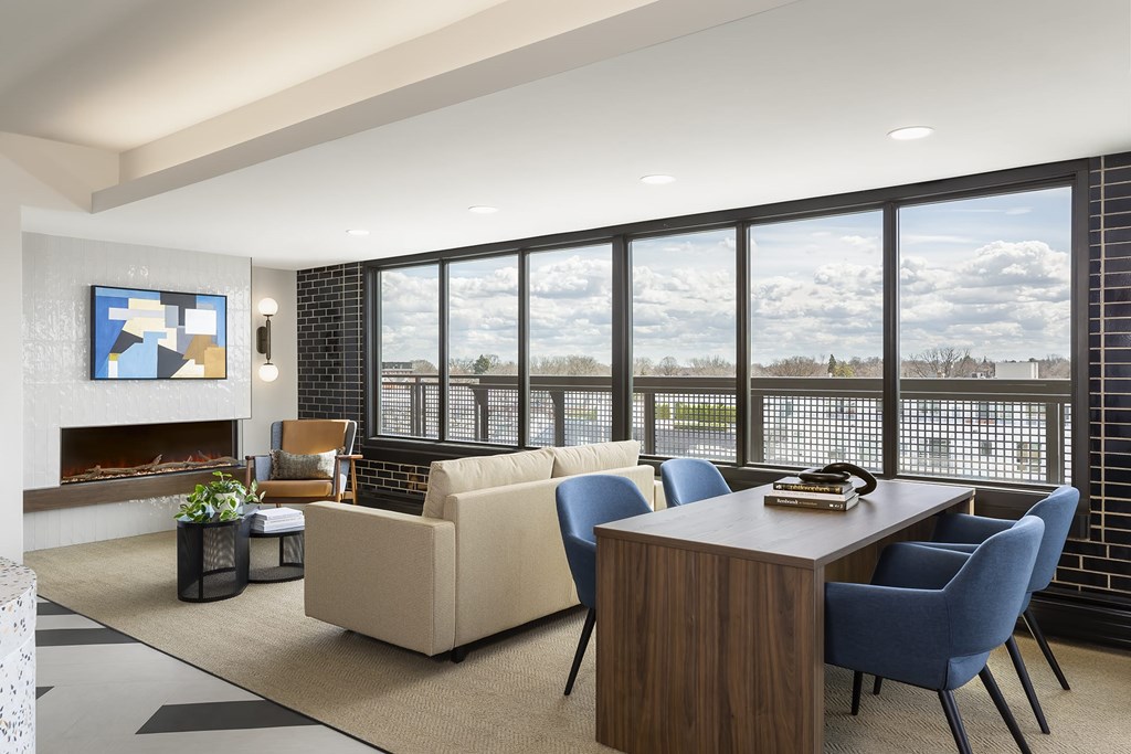 A sitting room with a couch and windows