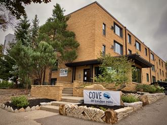 a large brick building with a sign in front of it