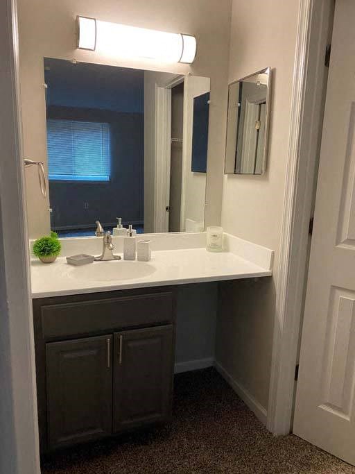 a bathroom with a sink and a mirror at ReNew Odenton, Maryland