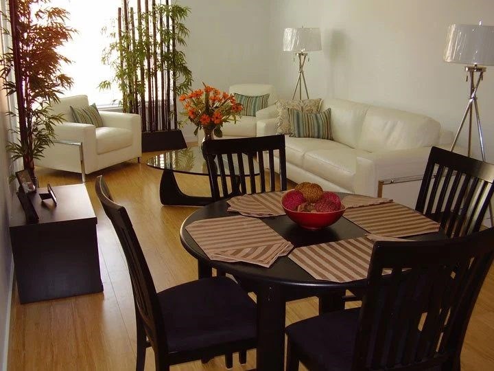 A dining room with a table set for four.