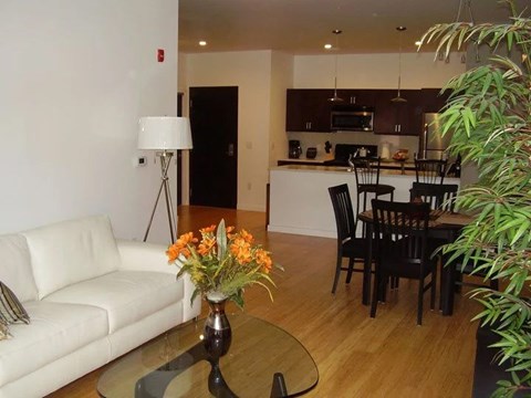 A white couch sits in a living room with a coffee table in front of it.