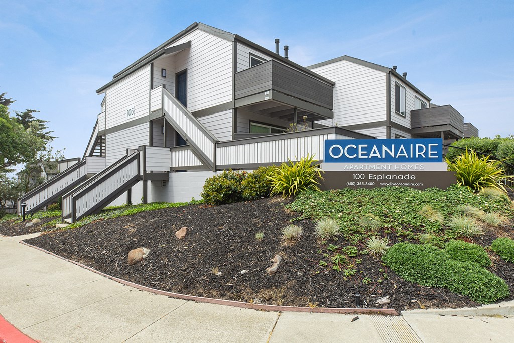 Monument sign of Oceanaire and apartment building  at OceanAire Apartment Homes, Pacifica, California