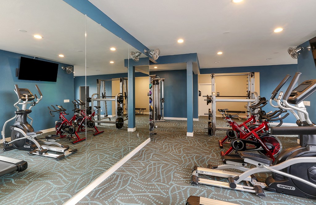 Fitness center with free weights and exercise equipment  at OceanAire Apartment Homes, Pacifica, CA, 94044