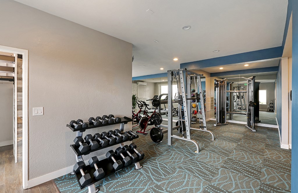 Fitness center with weights  at OceanAire Apartment Homes, Pacifica