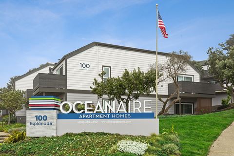 Oceanaire monument sign with apartment in background  at OceanAire Apartment Homes, Pacifica