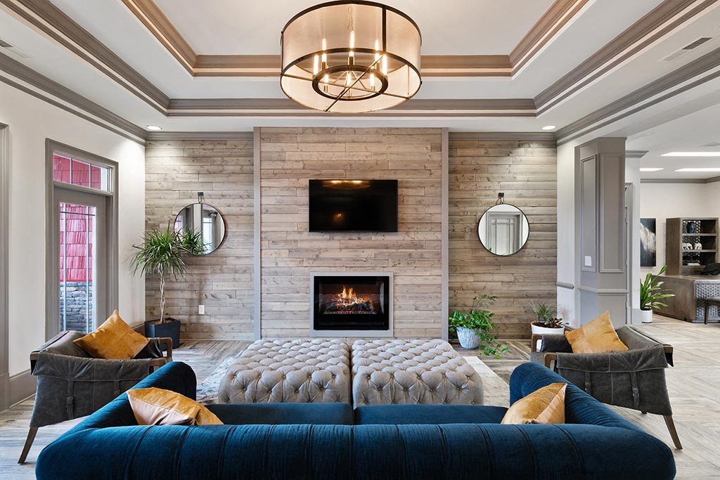 a living room with a blue couch and a fireplace  at ReNew Glenmoore, Glenmoore, PA