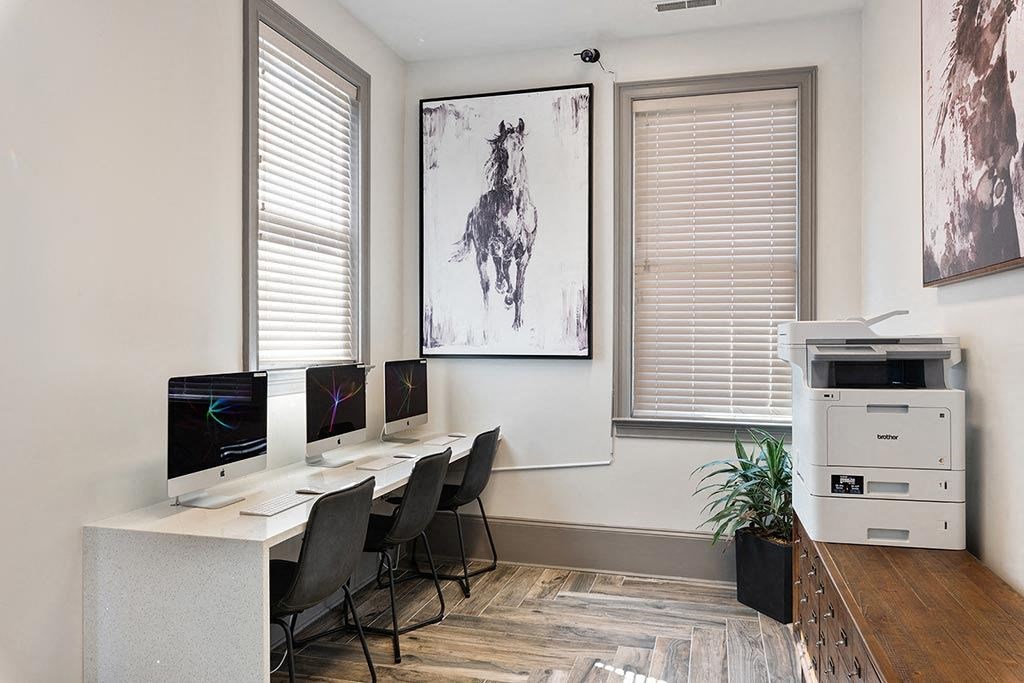 a room with three computer monitors and a printer  at ReNew Glenmoore, Glenmoore, 19343
