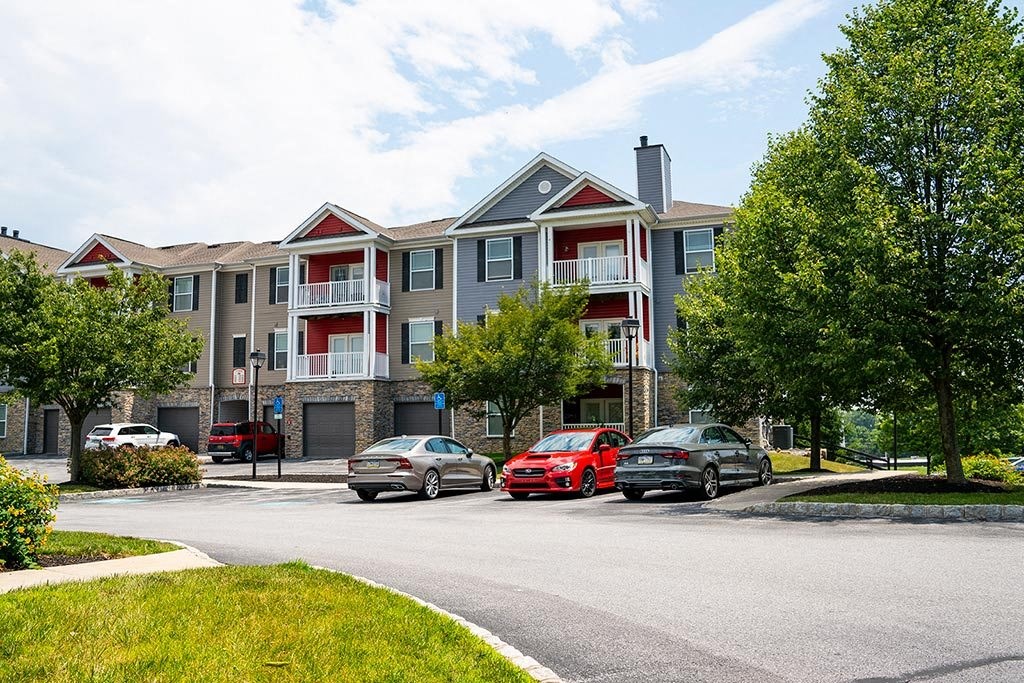a building with a parking lot and trees in front of it  at ReNew Glenmoore, Glenmoore