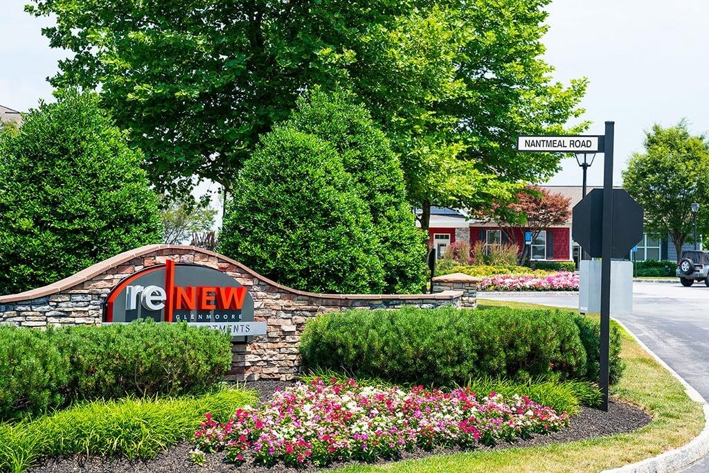 a sign in front of a building with flowers  at ReNew Glenmoore, Glenmoore, Pennsylvania