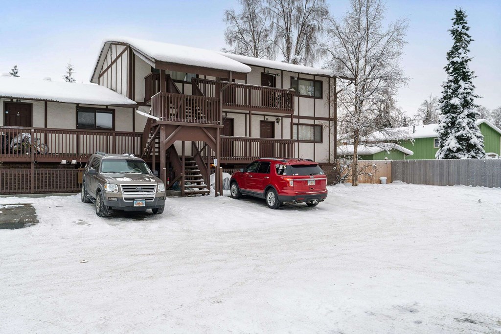 a house with snow on the roof and a red truck parked in front of it  at ReNew End Street, Alaska, 99577