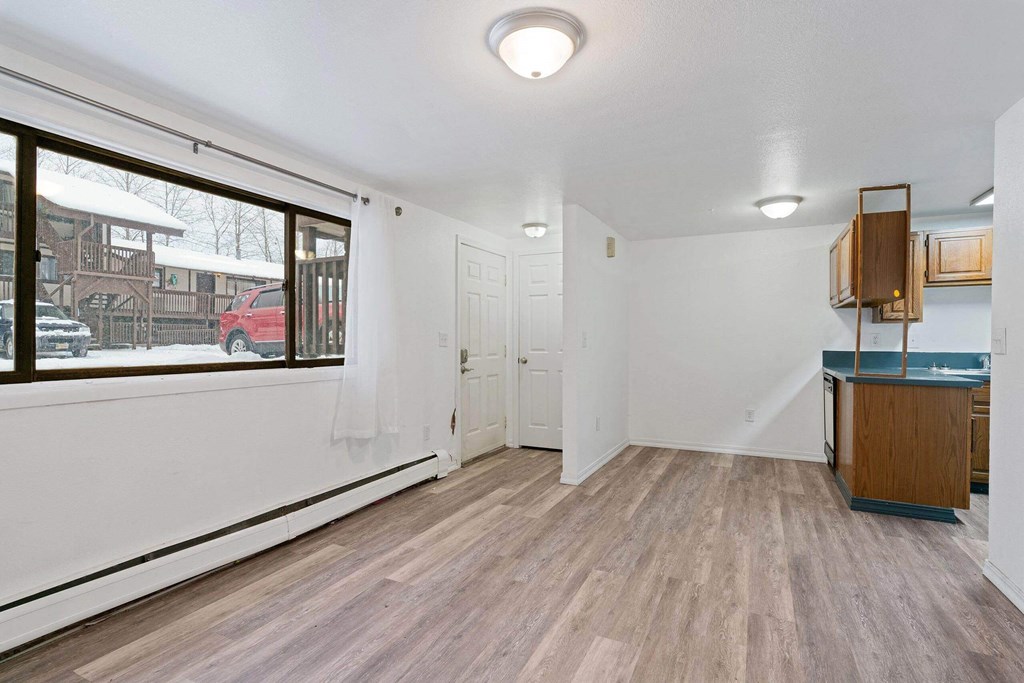 a living room with hardwood floors and a large window  at ReNew End Street, Alaska, 99577