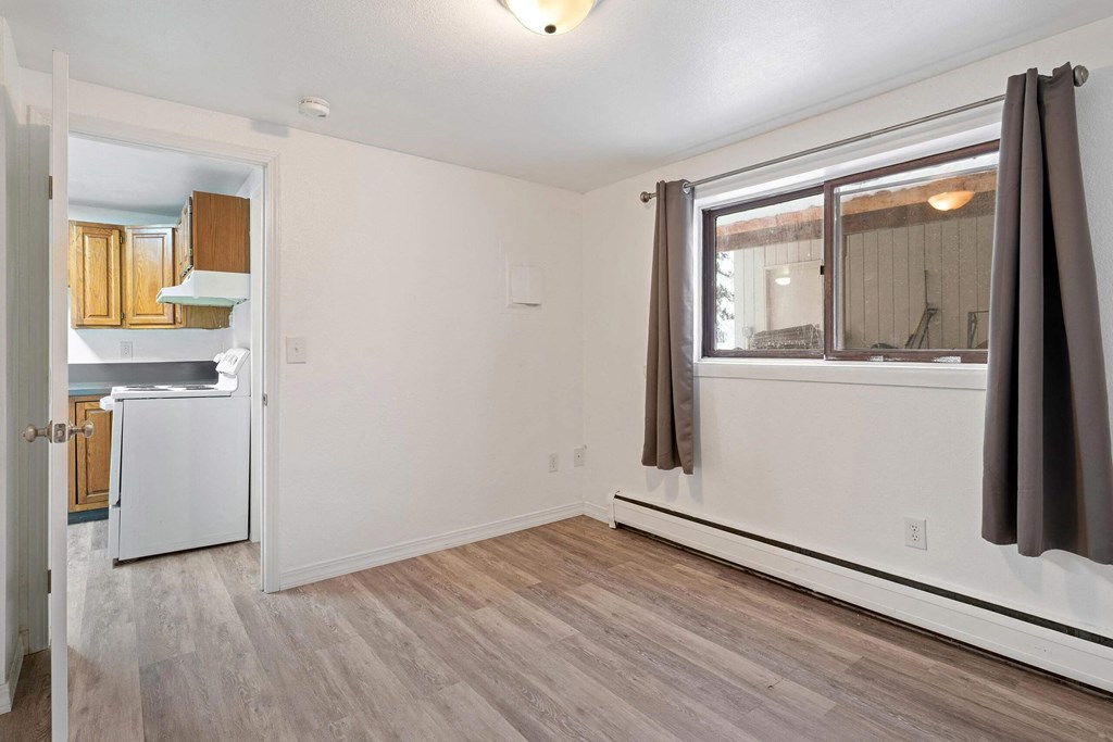 a bedroom with hardwood floors and white walls  at ReNew End Street, Eagle River, AK, 99577