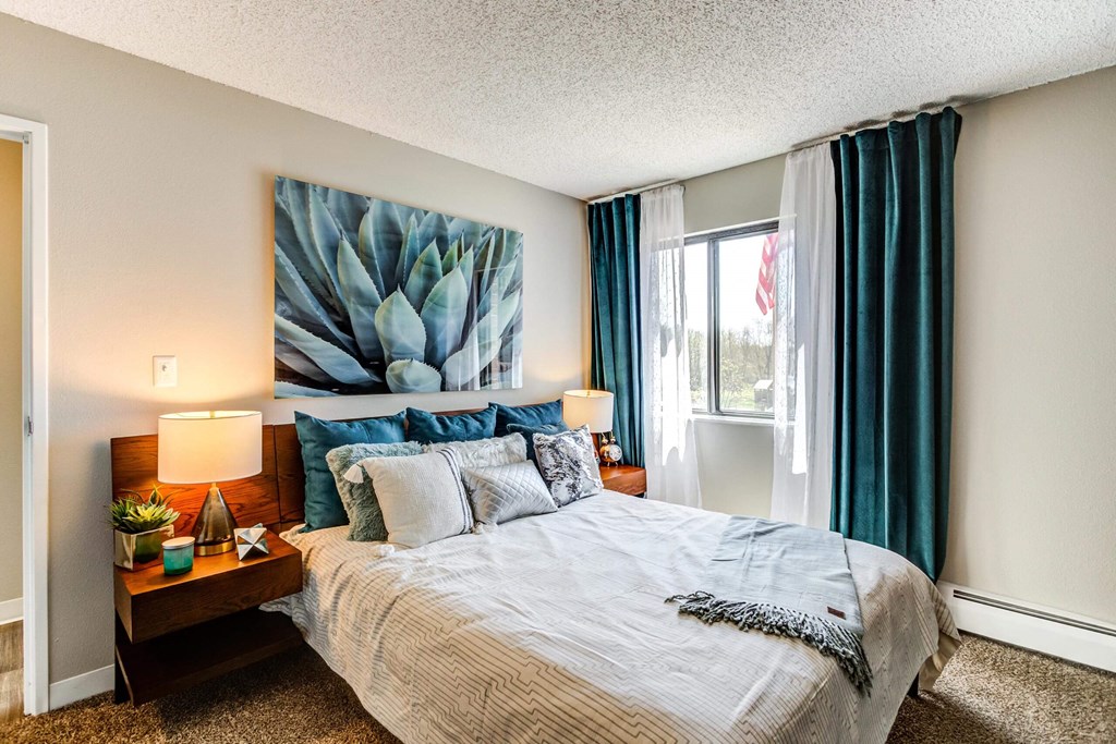 our apartments offer a bedroom with a king sized bed  at ReNew at Neill Lake, Eden Prairie, Minnesota