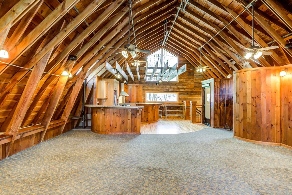 an open floor plan with a kitchen and dining area in a timber frame barn  at ReNew at Neill Lake, Minnesota, 55344