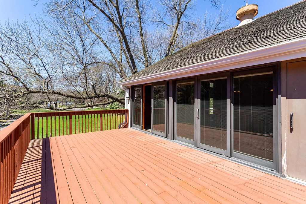 a large deck with sliding glass doors to the backyard  at ReNew at Neill Lake, Eden Prairie, 55344