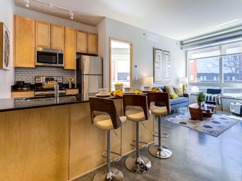 a kitchen and living room with a table and chairs