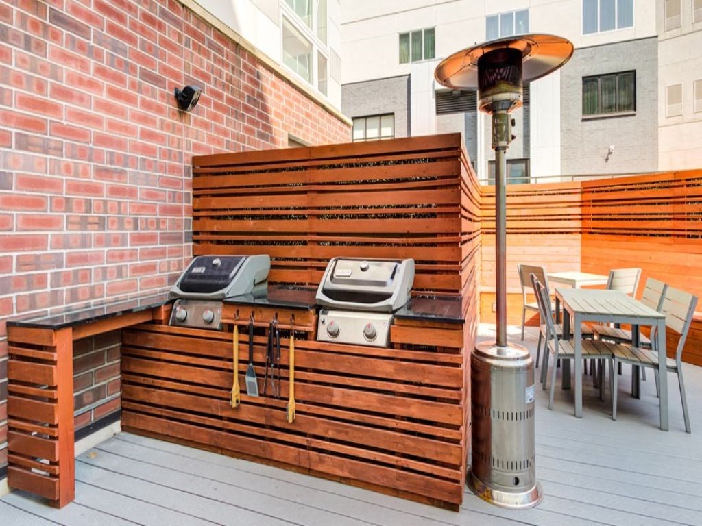 a patio with a bar and a grill on it