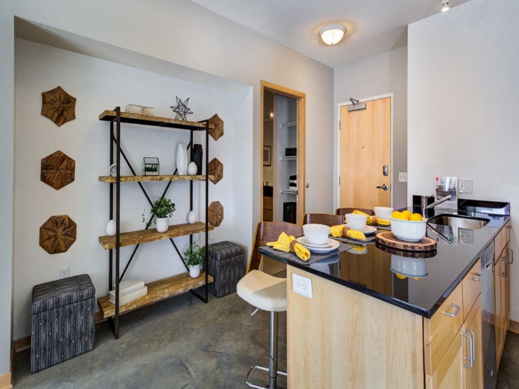 a kitchen with a counter top and a dining room table