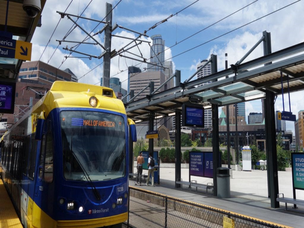 a blue and yellow metro train at a train station