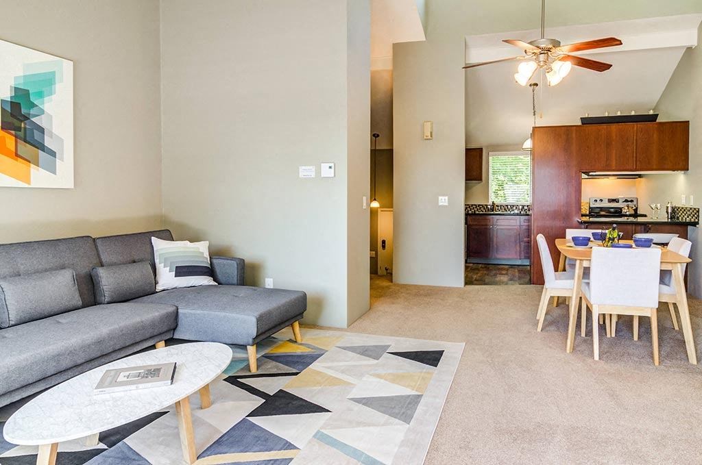 a living room with a couch a table and a ceiling fan at The Bluffs at Mountain Park, Oregon