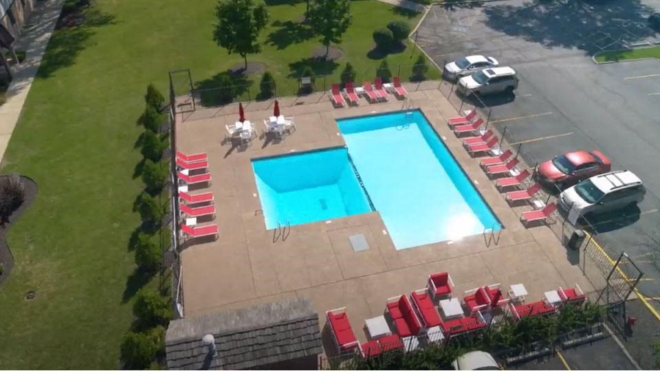 a swimming pool with a bunch of chairs around it