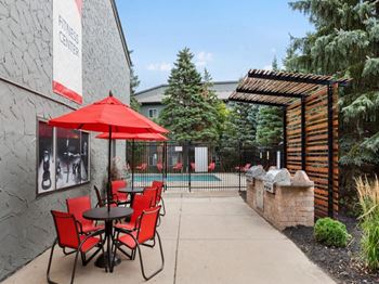 A patio with a table and chairs is outside a gym.