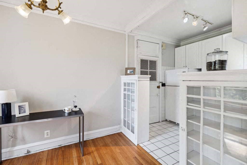 a kitchen with a white refrigerator and a door way at The Bryant at Oak Park I & II, Illinois, 60302
