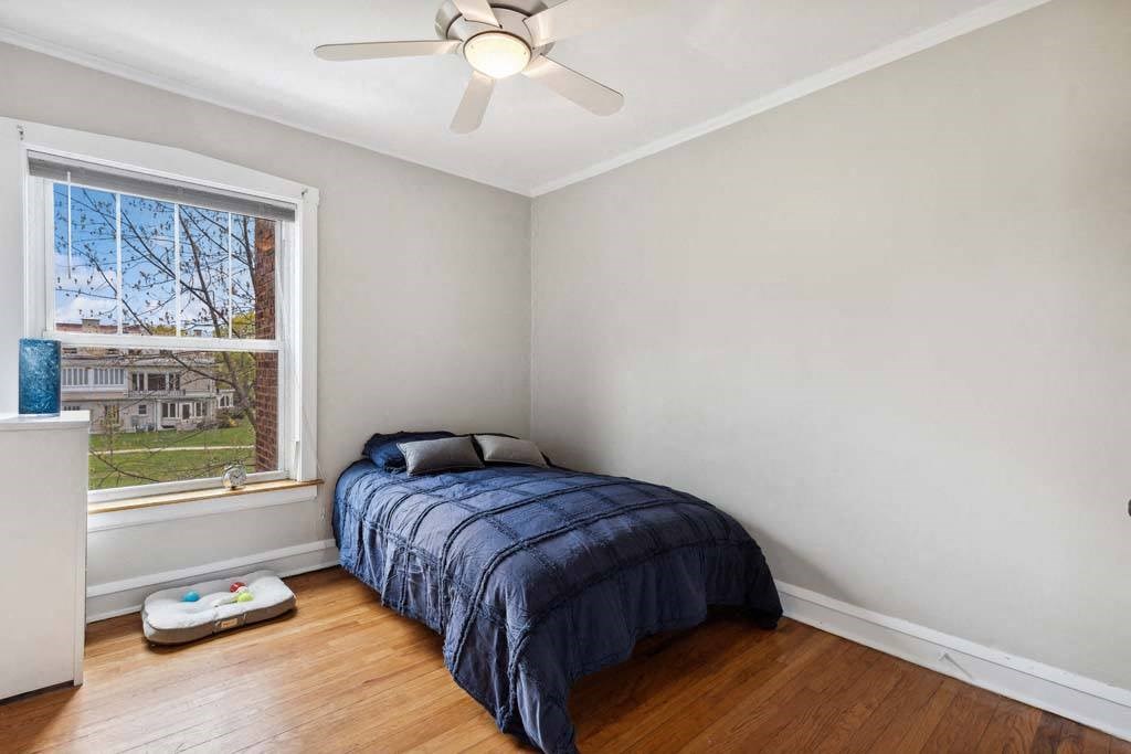a bedroom with a bed and a ceiling fan at The Bryant at Oak Park I & II, Oak Park, IL