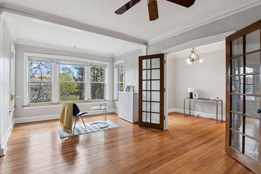 the living room has a hardwood floor and a large window at The Bryant at Oak Park I & II, Oak Park, 60302