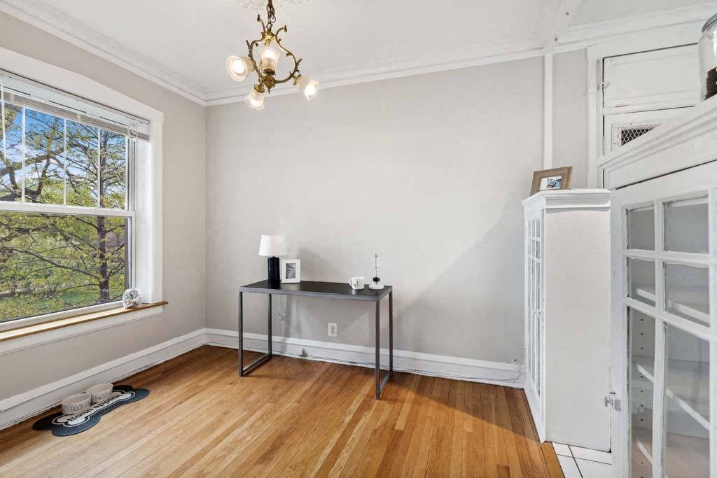 an empty room with white walls and a table in the corner at The Bryant at Oak Park I & II, Oak Park, IL