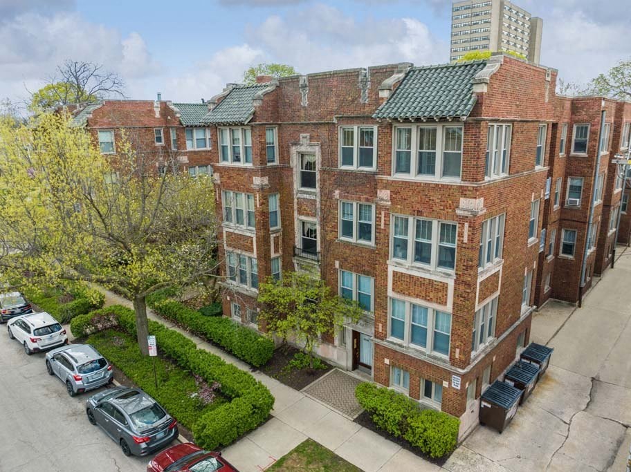 an aerial view of a brick apartment building with a parking lot at The Bryant at Oak Park I & II, Illinois, 60302