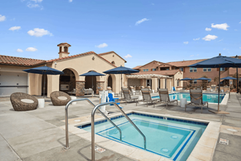 a swimming pool with chairs and umbrellas at the resort