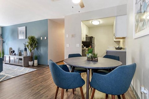 a room with a table and chairs and a kitchen in the background at Renew Madison, Madison, WI