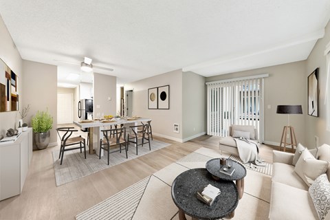 A living room with a dining table and chairs.